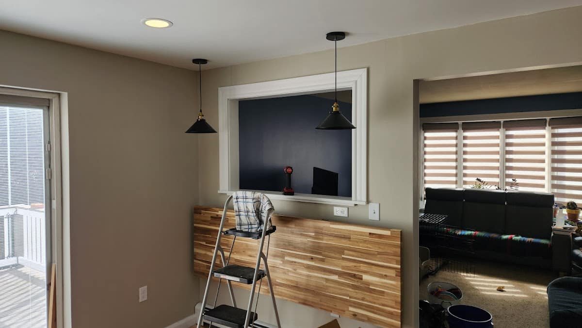Black pendant lights and recessed lighting installed by Electric Wizard